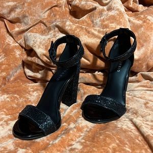 Women’s black sequined heels.